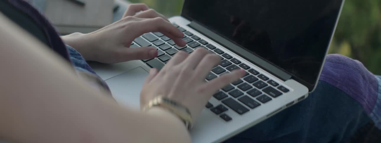 A person si typing on their laptop