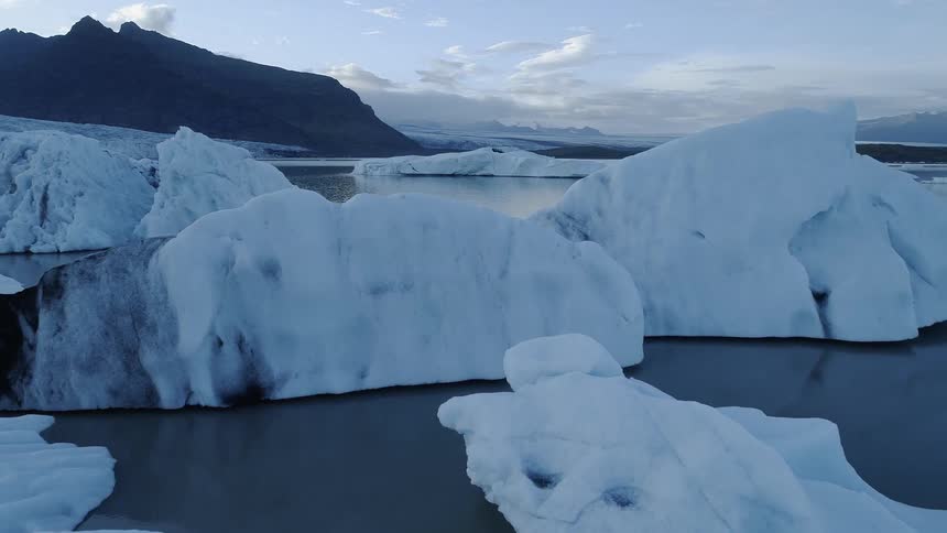 Ice and snow float on a lake in the wilderness