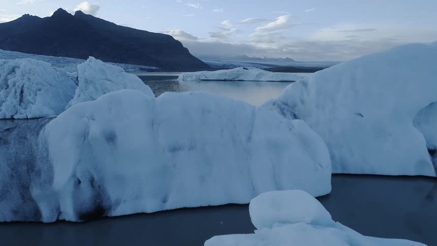 Chunks of glacier ice floating in cold ocean water