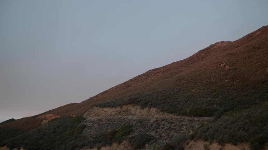 A vehicle drives in the mountains