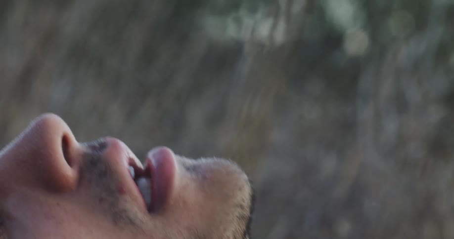 A man breathes heavy laying in the grass