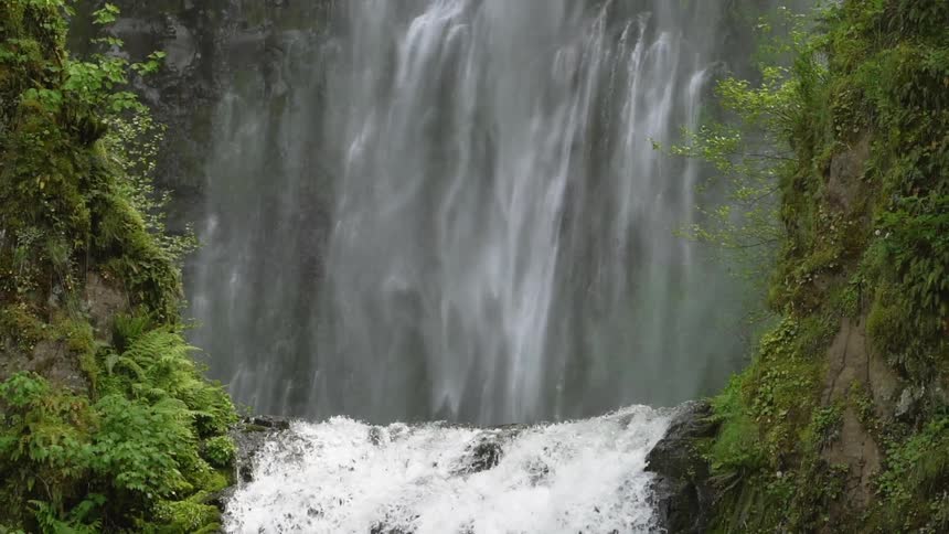 Water flows and rushes down a waterfall