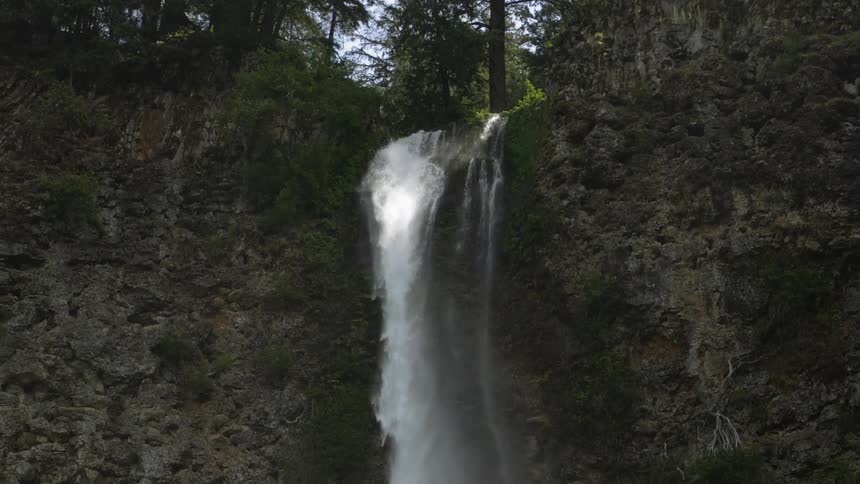 The waterfall slowly falls from above