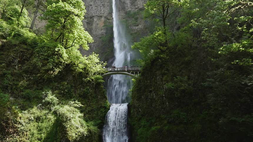 A waterfall flows over a cliff in the wilderness