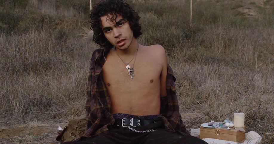 A man exhales heavily in the grass