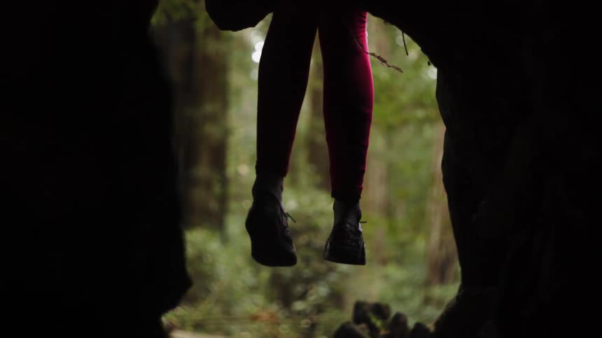 Legs dangle in the woods