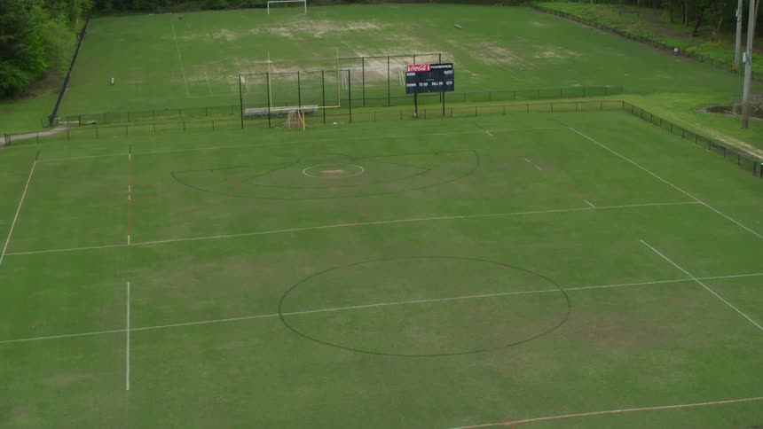 The green field leads to a scoreboard