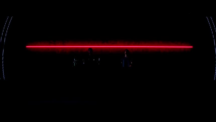 Music band plays in front of light projections