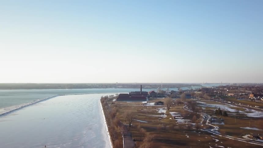 The fields by the shore have some snow