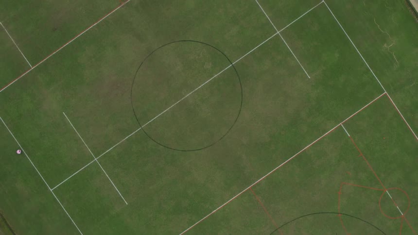 A soccer field is standing empty during the day