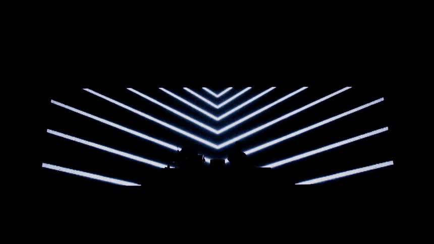 Two electronic musicians perform on stage