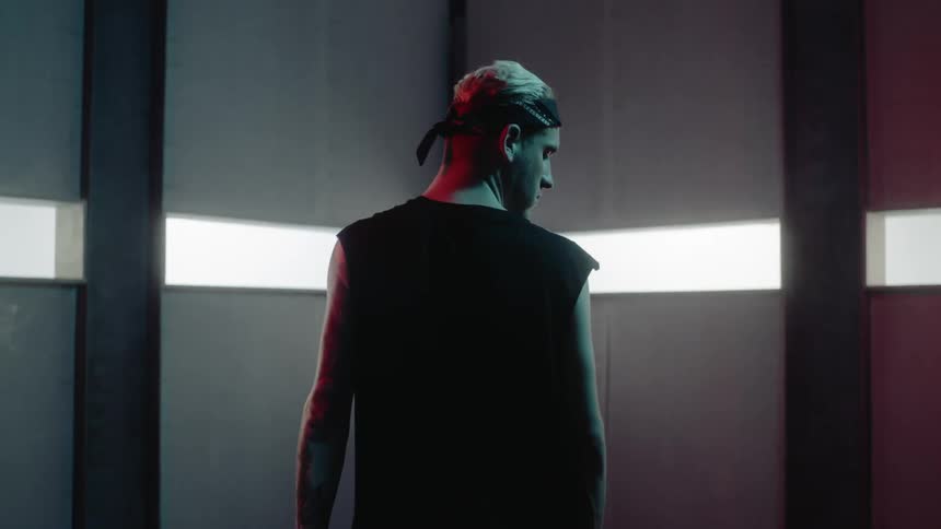 The man looks up in the dark room