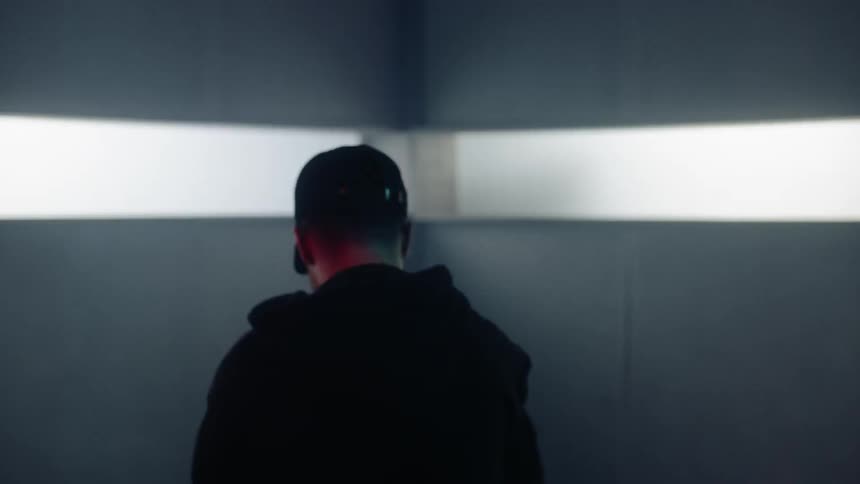 The man is dancing in the dark room