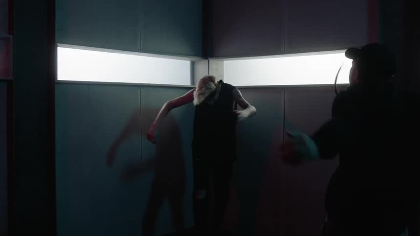 Two people dance together in the dark corner