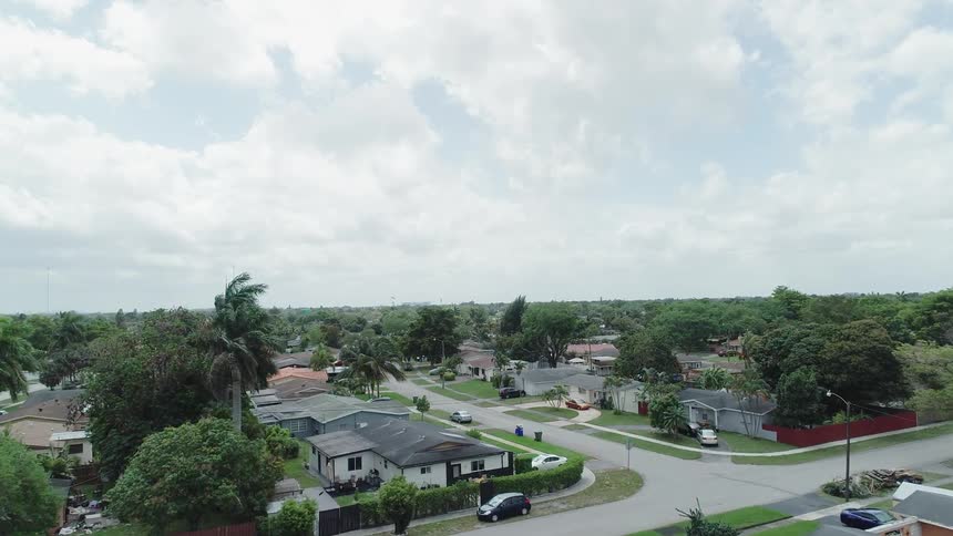Clouds are hanging above a neighborhood during the day