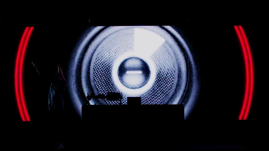 A dj performs in front of a projection