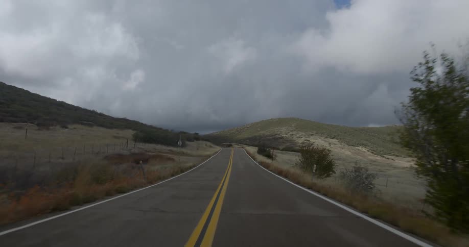Going down an empty two lane road in a country setting