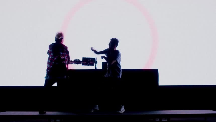 Two people perform on stage