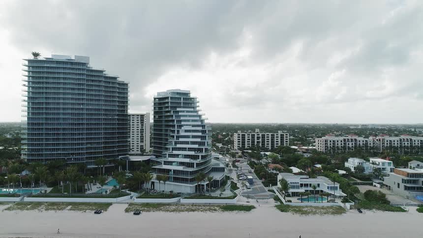 The tall buildings are right near the sand