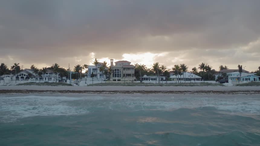 The blue water leads to homes on the shore