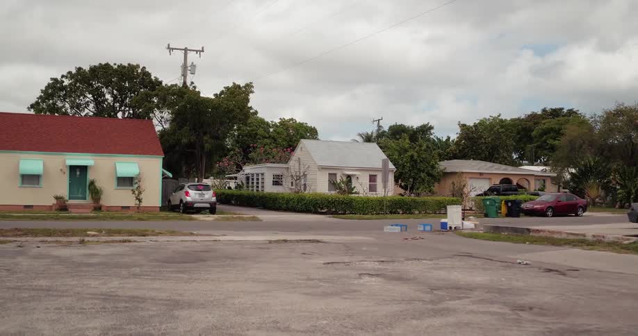 An empty lot along a road in a neighborhood