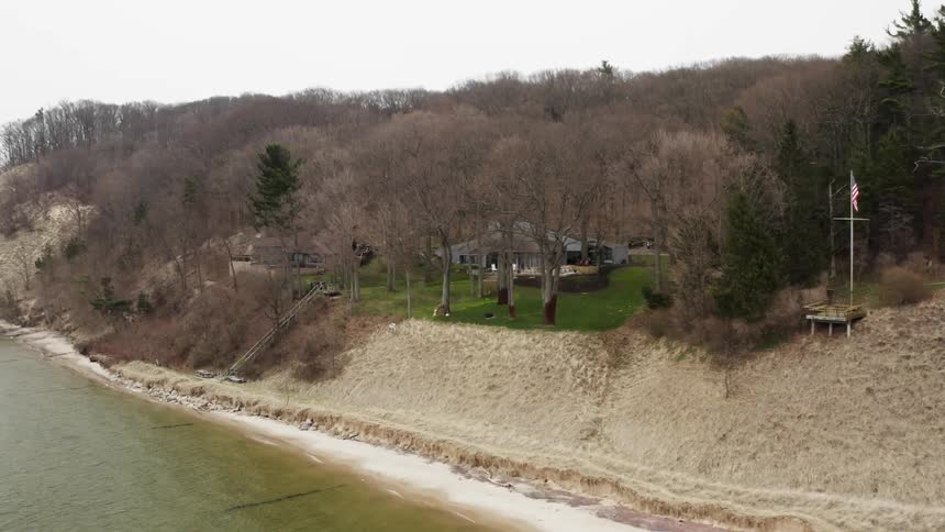 The water crashes against the hills by the shore