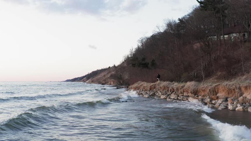 The waves hit the rocky shore