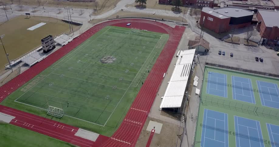 College running track and football field on sunny day
