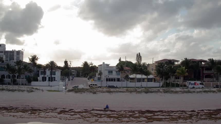 Cars drive in a coastal town