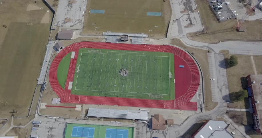 An athletic field sits in a town