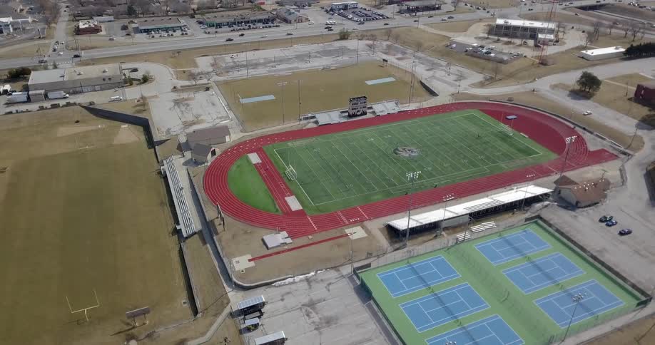 Cars drive by the football stadium