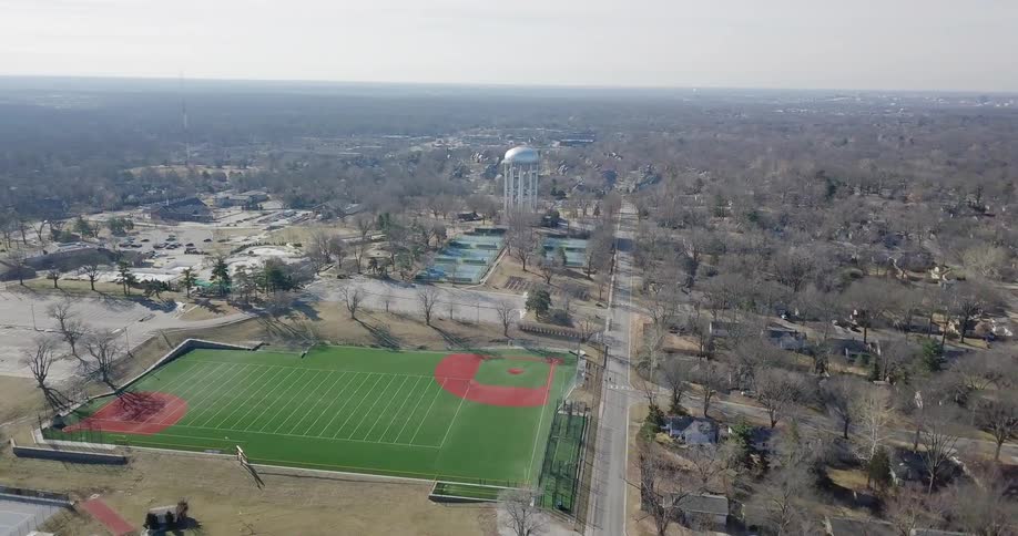An athletic field sits in a town
