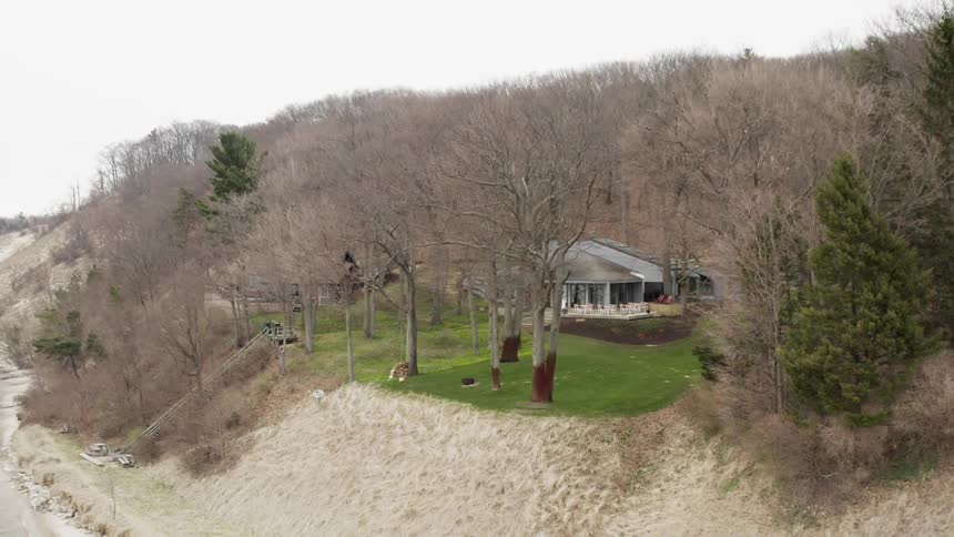A rural house sits on a shoreline