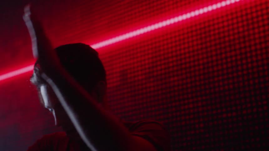 A man is dancing in a dark club
