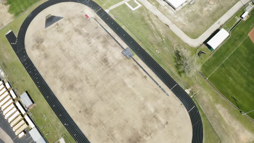A racetrack sits next to buildings