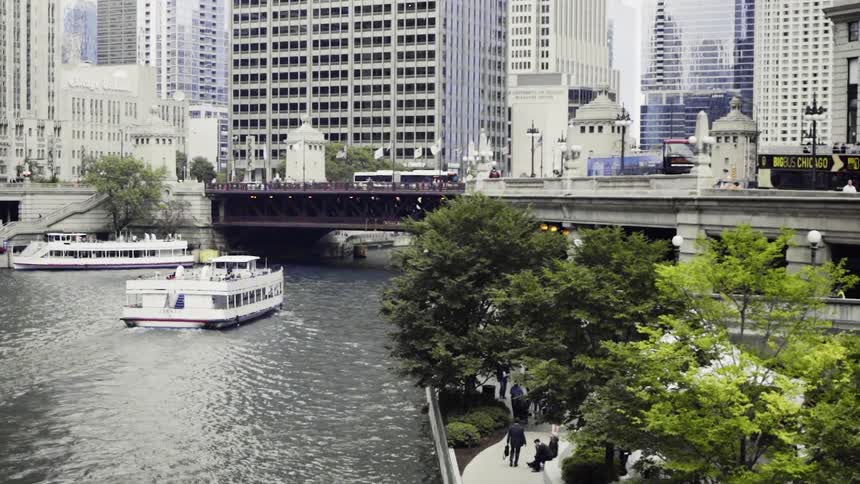 A ferry boat passes towards the city bridge