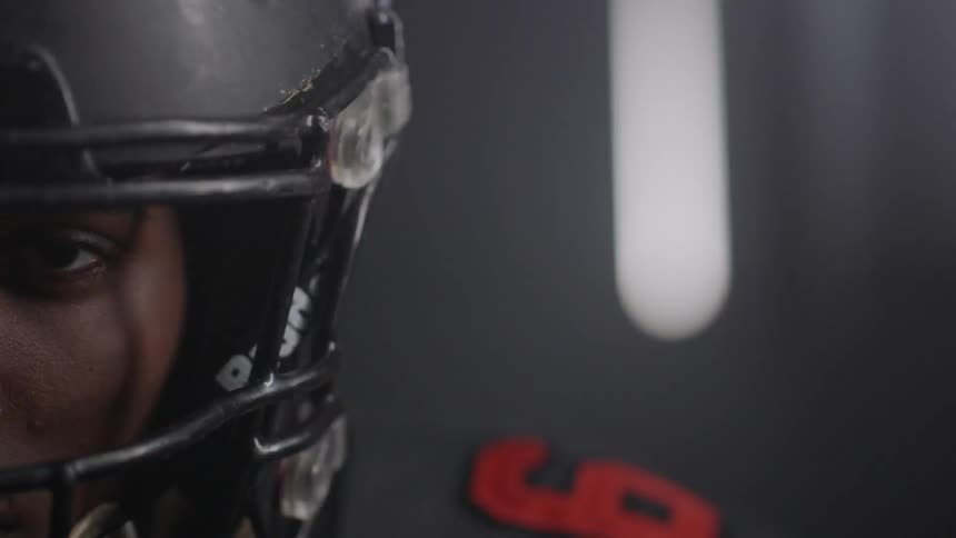 The lights flash on the football player in the dark