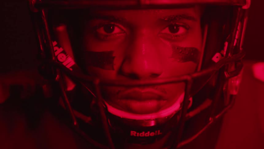 The football player is in the dark