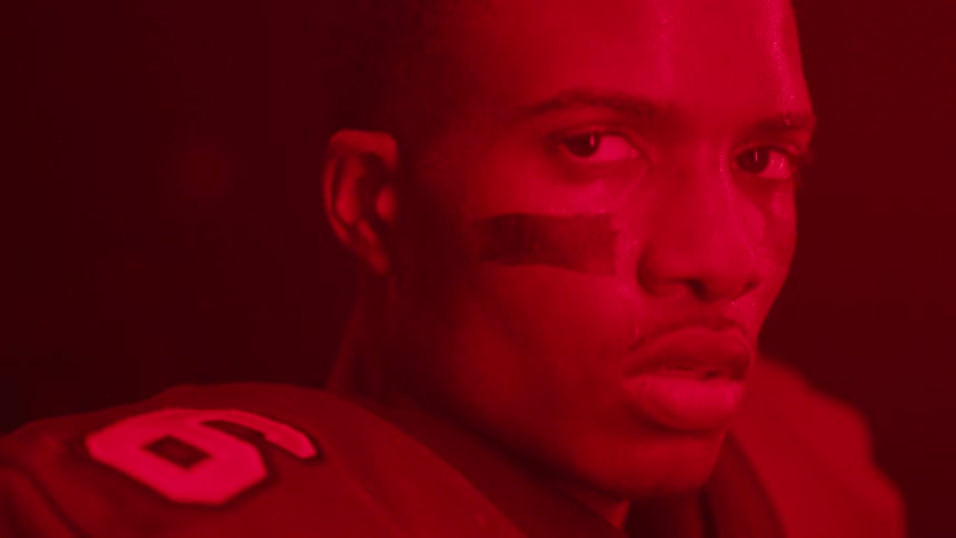 A football player is covered in red light