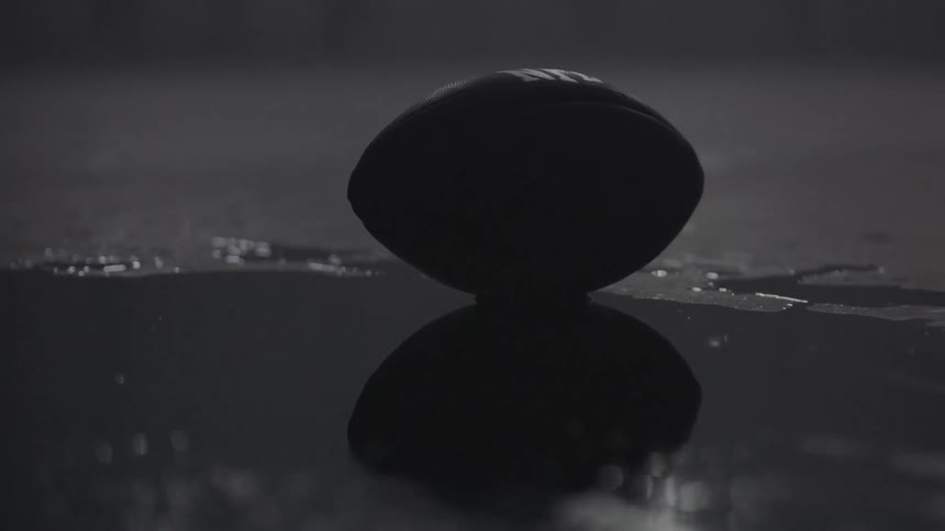 A football sits on the wet floor