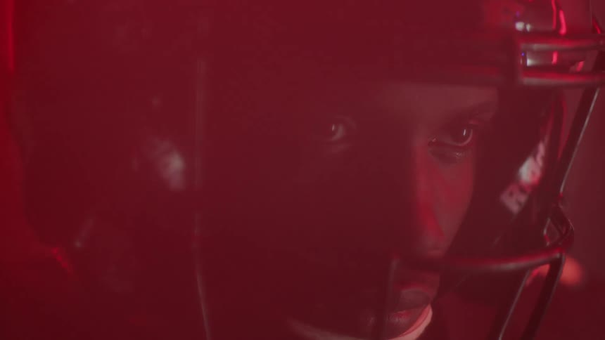 Red lights flash around a football player