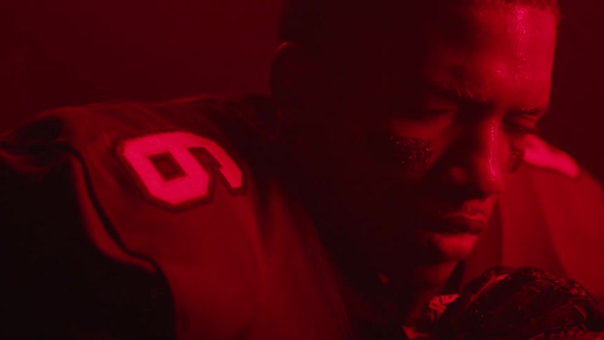 Red lights flash on a football player