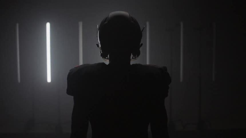 Lights flash on and off behind a football player in uniform