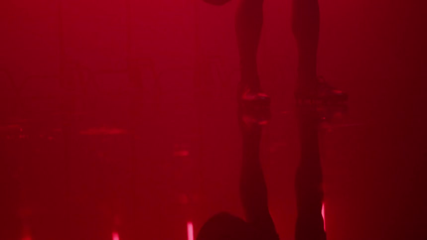 A football player stands in a room with red lights