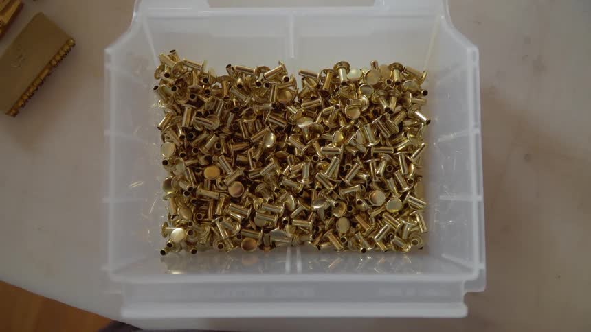 Pile of small metal items in a bin