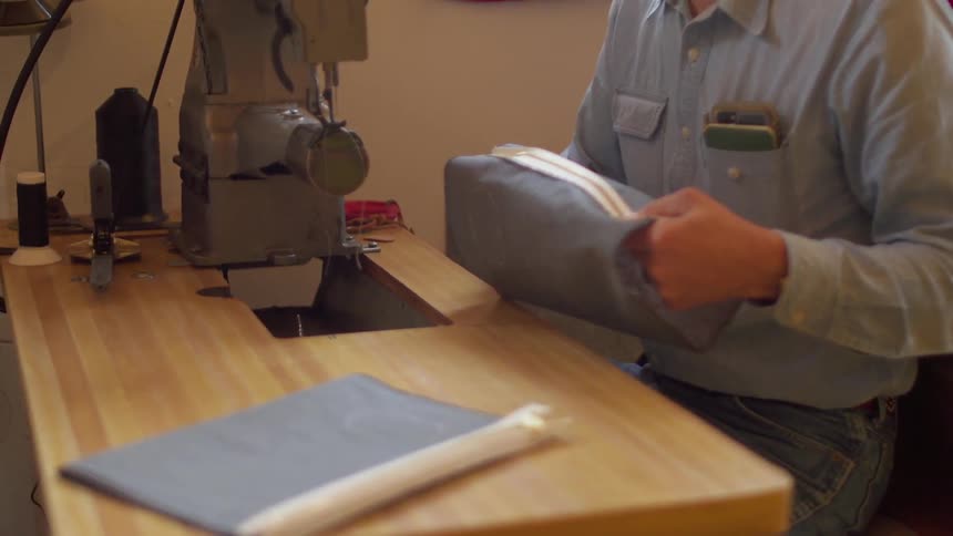 A man is working with cloth