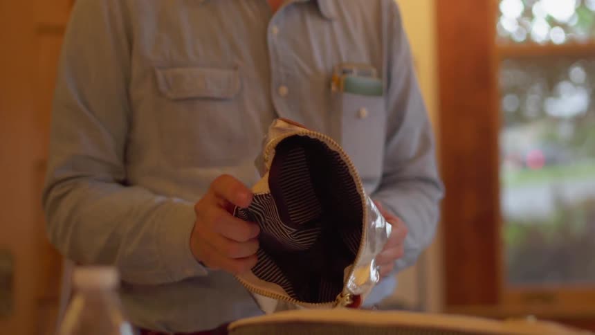 A man examines a gold bag