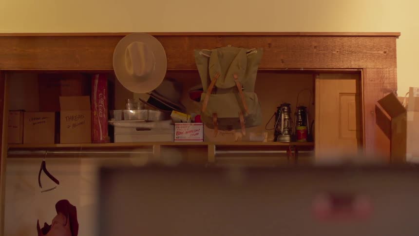 Boxes sit on a closet shelf