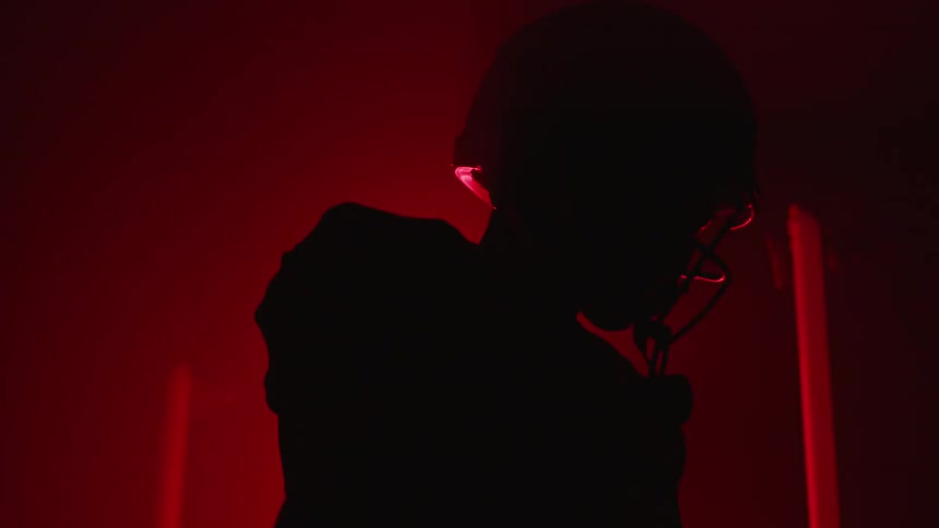 A football player stands in a room with flashing lights