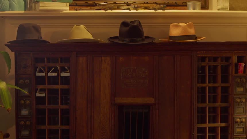 Hats sit on a wood table